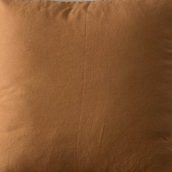 clay cushion on a white chair with a neutral background