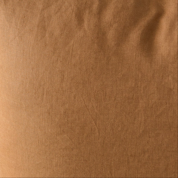 Brown pillow on a chair with a neutral background