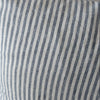 Striped blue and white pillow on a chair with a neutral background