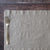 Silver fork on a textured linen placemat with a wooden surface background