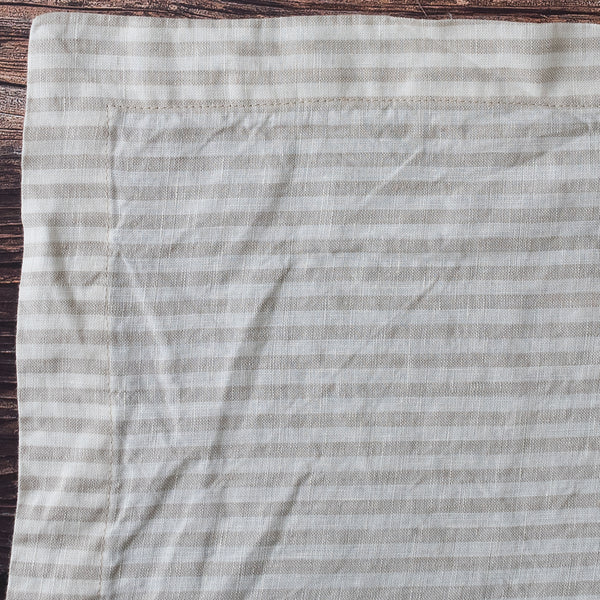 Natural Flax Stripe 100% Linen Placemat with a subtle pattern on a wooden surface