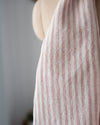 Close-up of a striped dress on a mannequin against a neutral background