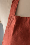 Close-up of a red apron on a beige background
