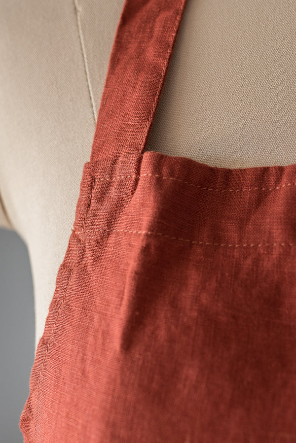 Close-up of a red apron on a beige background