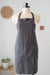 Dark gray apron on a mannequin against a light background