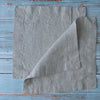 Natural 100% Linen Cocktail Napkins on a rustic wooden surface