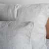 Close-up of Natural European linen pillowcaseslinen pillows on a bed.
