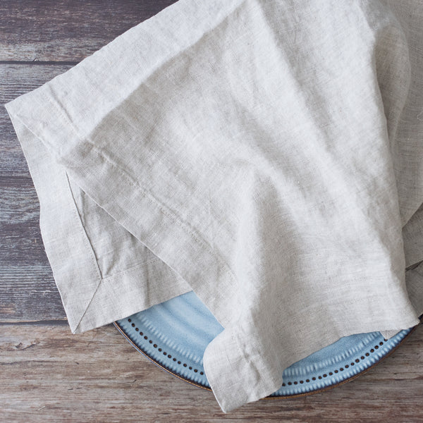 Folded natural napkin on a wooden surface