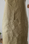 Close-up of a beige apron with a plain background