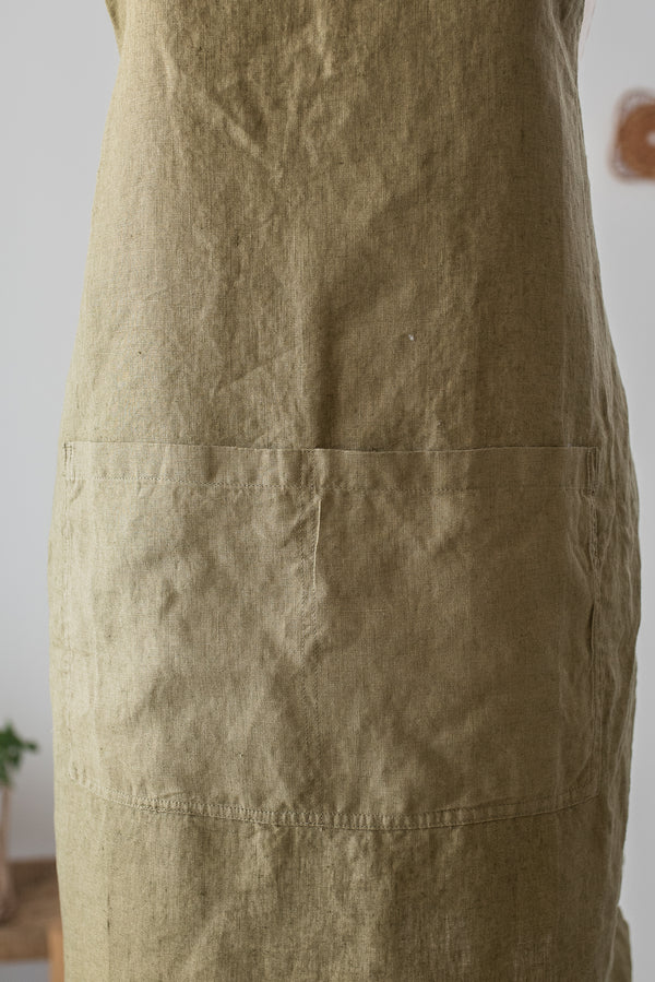 Close-up of a beige apron with a plain background