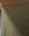 olive table runner on wooden dining table