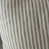 Olive Striped pillow with brown and white lines on a neutral background
