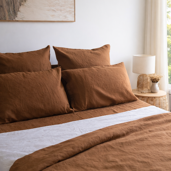 Tobacco brown bedding set on a bed with a lamp and decor in the background
