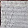 Natural Flax Stripe 100% Linen Placemat with a subtle pattern on a wooden surface