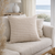 Nature Gingham on a beige sofa with a window and lamp in the background