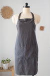 Dark gray apron on a mannequin against a light background