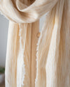Close-up of a beige scarf with a blurred background