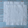 Pure White 100% Linen Cocktail Napkinson a wooden surface