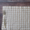 Nature Gingham placemat with a fork on a wooden surface