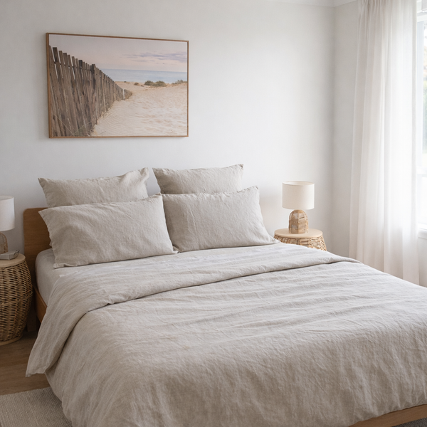 Neatly made bed with beige bedding in a bedroom setting.