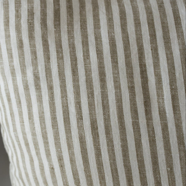 Olive Striped pillow with brown and white lines on a neutral background